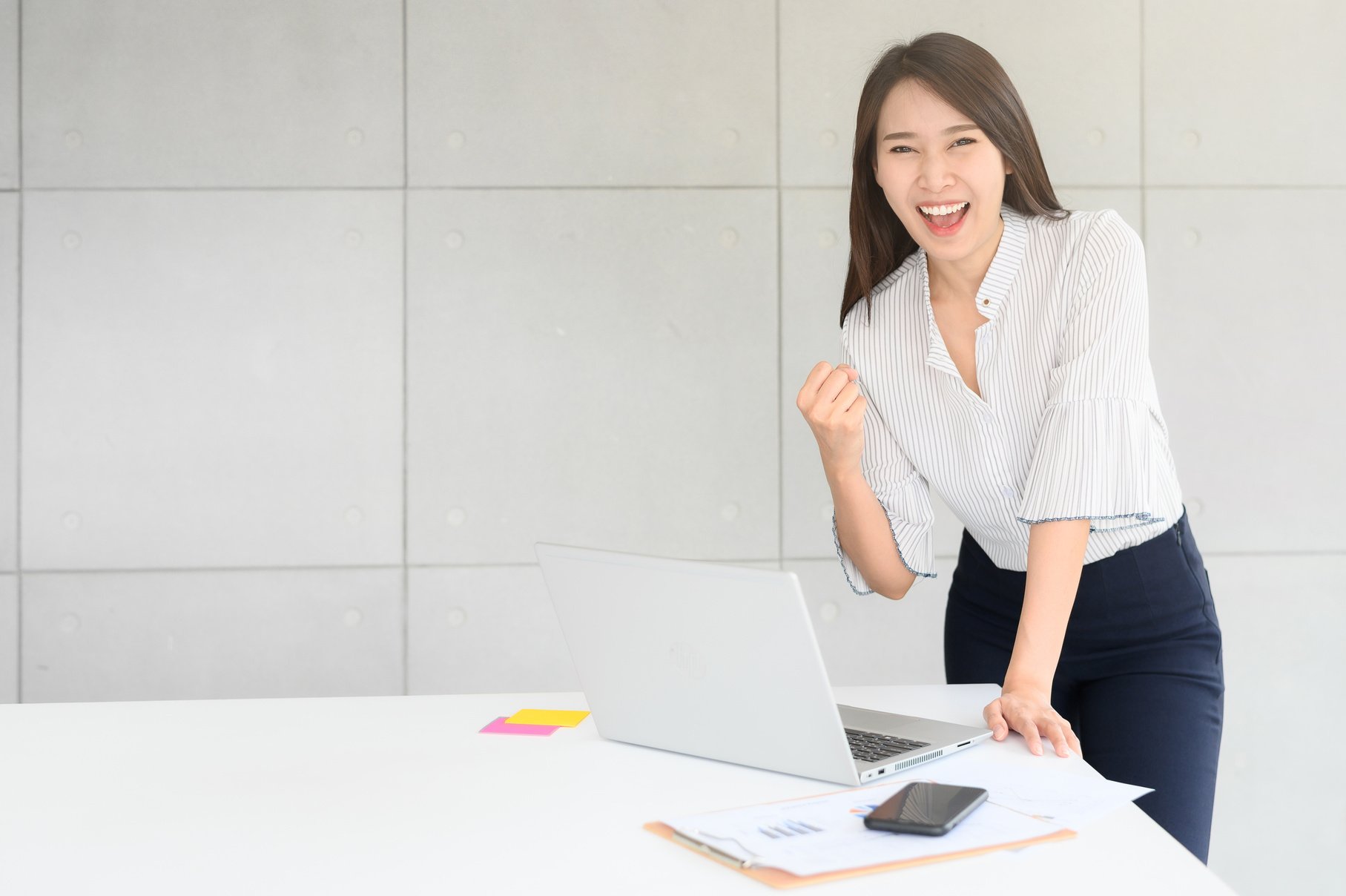 Woman Celebrating Success with Closed Fist Pose